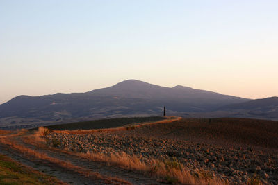 Scenic view of landscape against clear sky during sunset