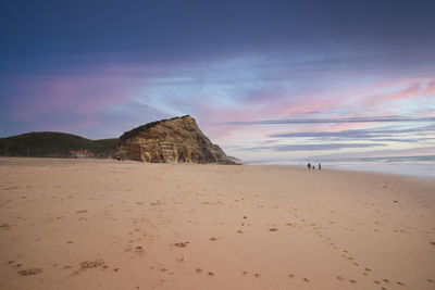 Scenic view of beach against sky during sunset
