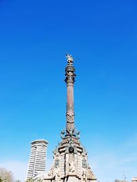 Low angle view of statue against blue sky