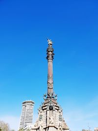 Low angle view of statue against blue sky