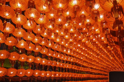 Low angle view of illuminated lanterns hanging from ceiling