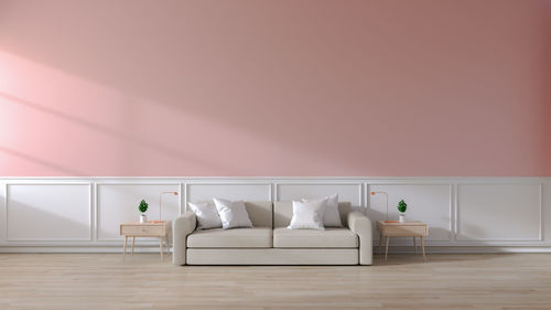 Modern room interior of living room,brown sofa on wood flooring and pink wall
