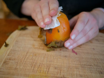 Close-up of person preparing food on cutting board