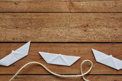 High angle view of white paper on wooden table