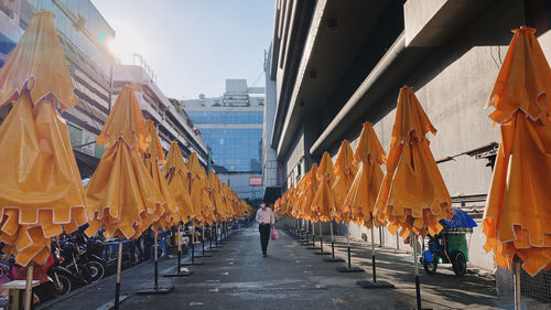 People on street in city against sky