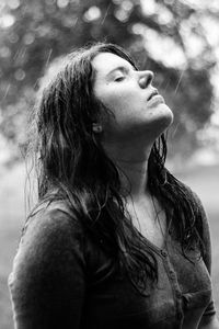 Close-up of young woman against tree