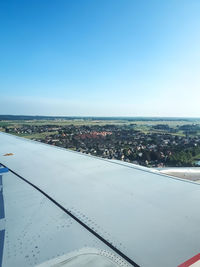 Scenic view of cityscape against clear blue sky