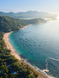 High angle view of sea and mountains against sky