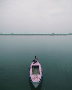 Boat moored on sea against sky