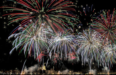 Low angle view of firework display at night