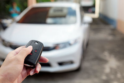 Cropped hand holding car alarm