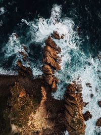 High angle view of rocks in sea