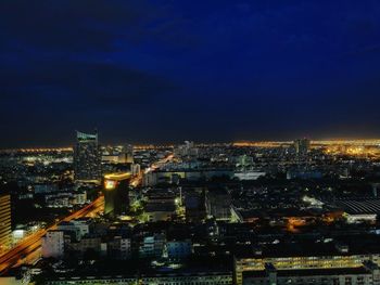 High angle view of illuminated city buildings against sky