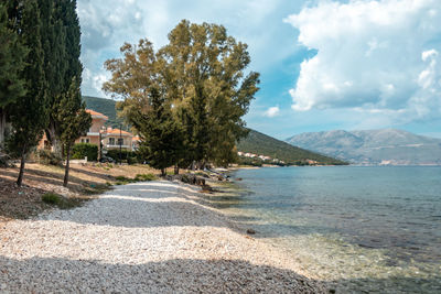 Scenic view of road by sea against sky