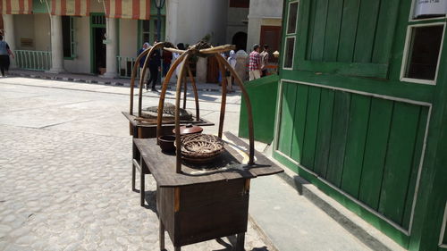 Chairs on table by street in city