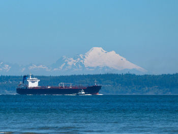 Ship sailing on sea against sky