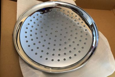 High angle view of metal grate on wall