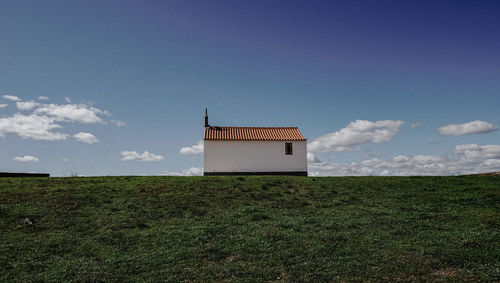 House on field against sky