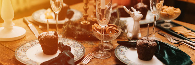 Tablescapes and christmas and new year time. decorated festive kitchen cozy table with glasses