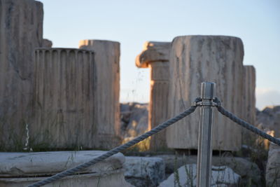 Railing by temple of olympian zeus against clear sky