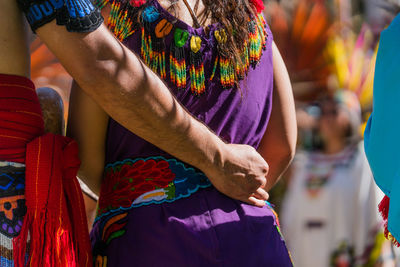 Cropped image of man arm around woman