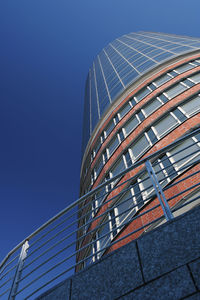 Low angle view of modern building against clear blue sky