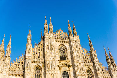 Low angle view of duomo di milano against clear sky