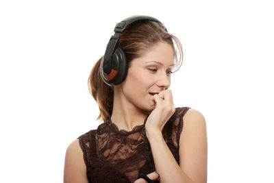 Young woman looking away against white background
