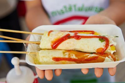 Midsection of woman holding food