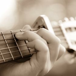 Close-up of hands playing guitar