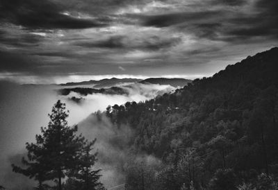 Scenic view of mountains against sky during foggy weather