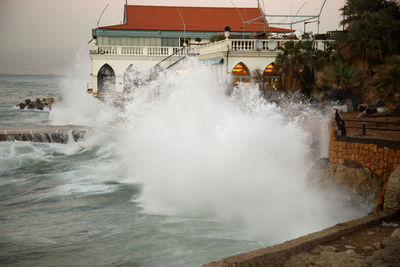 Scenic view of sea against buildings