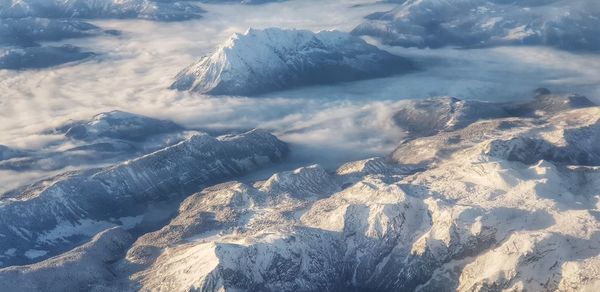 Scenic view of snow covered mountains against sky