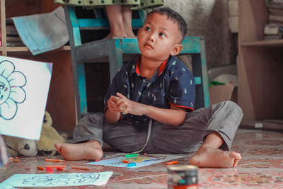 Portrait of young woman working at table