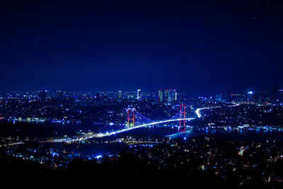 High angle view of city lit up at night