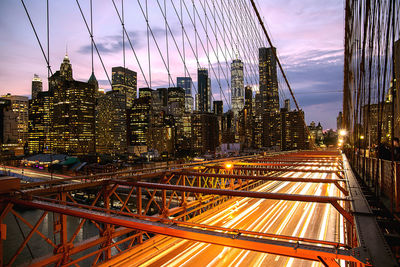 Illuminated cityscape against sky at night