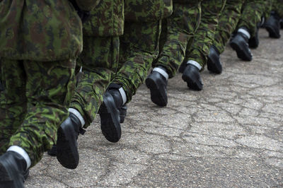 Low section of soldiers marching on footpath