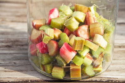 Close-up of chopped vegetables in jar on table