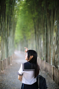 Young woman standing on a tree