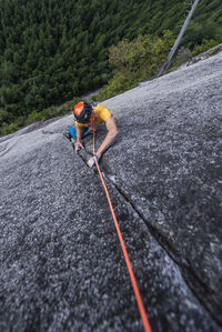 Man rock climbing cracks in granite very exposed in squamish chief