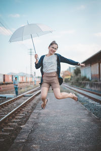 Full length of boy on railroad track against sky