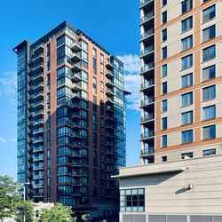 Low angle view of modern buildings against blue sky