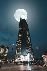 Low angle view of illuminated buildings against sky at night