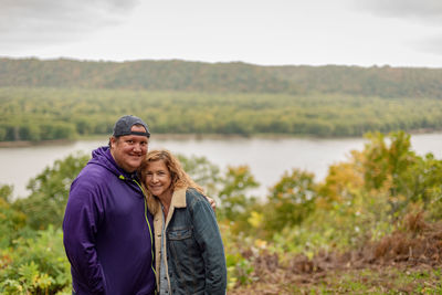 Portrait of smiling man standing in lake