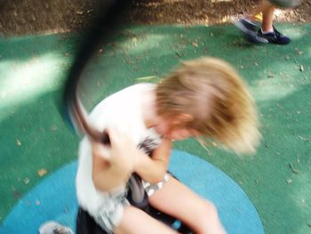 Blurred motion of boy playing in park