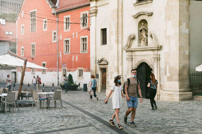 People walking in front of building