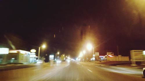View of illuminated road at night