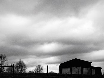 Low angle view of buildings against cloudy sky