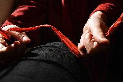 Midsection of person holding fabric