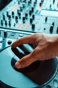 Cropped hand of musician adjusting sound mixer